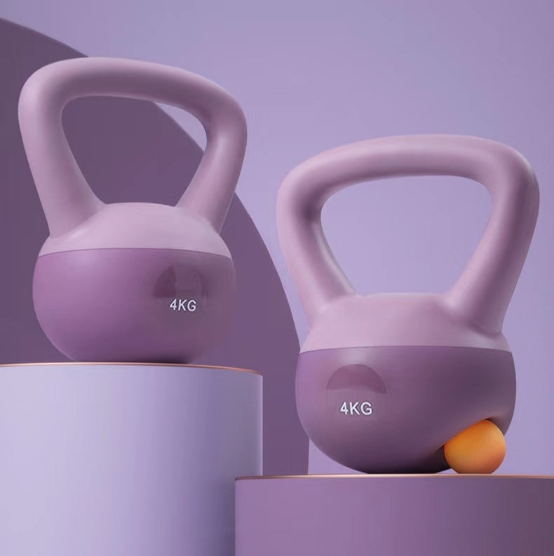 Two purple 4KG kettlebells on a gradient purple background